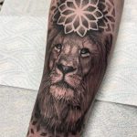 Tatuaje de león y mándala antebrazo