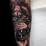 tatuaje de león rugiente en el brazo hombre